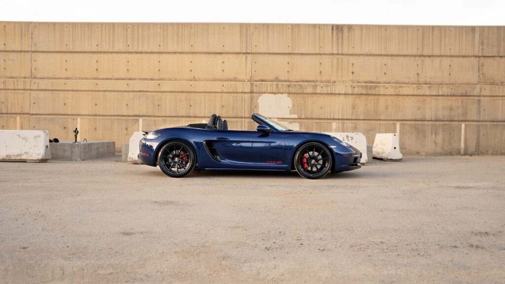 Dynamic blue Porsche 718 Boxster convertible